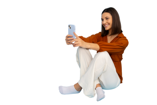 Smiling woman working on mobile phone, legs crossed, isolated background