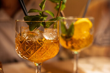 Refreshing cocktails with fresh mint and lemon served in elegant glasses at a cozy evening gathering