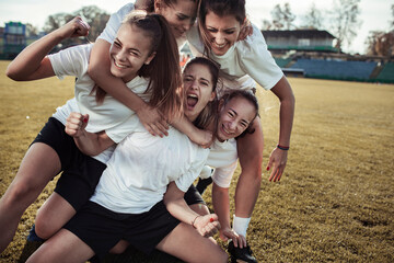 Girls soccer team celebrating goal on the field