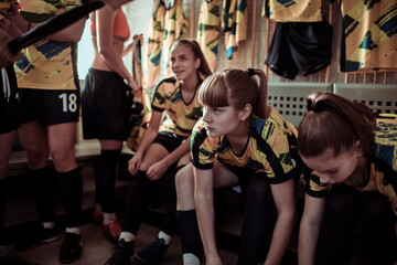 Girls soccer team getting ready in locker room before game