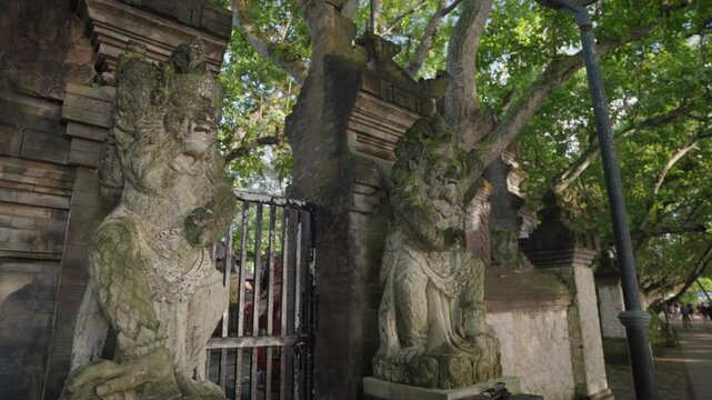 A traditional candi bentar split gateway stands at the entrance of a seaside temple on Sanur Beach, Bali, Indonesia