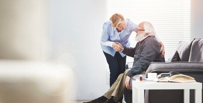 Mature, loving caregiver caring for a senior patient at an assisted living home. Healthcare worker comforting a confused man suffering with alzheimers or dementia, showing kindness and support