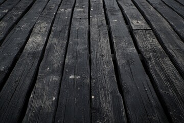 Close-up view of a weathered, dark wooden plank floor.