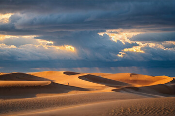 Sand dunes in under stormy clouds