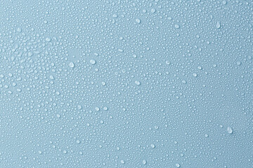 Many water drops on light blue background