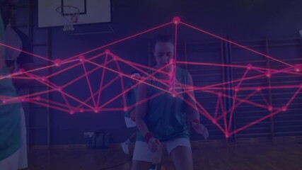Female basketball players drilling in gym, with red nodes overlay illustrating sports analytics - Powered by Adobe