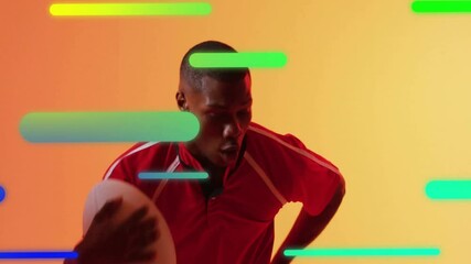 male athlete leaning and holding football in studio, showing sports technology neon bars