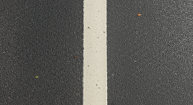 Close-up on a freshly paved road section, features a straight white line marking, symbolizing guidance and clear direction in traffic flow.