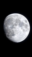 A detailed close-up of a gibbous moon against a pitch-black sky, showcasing its craters and varied surface textures