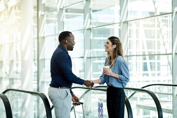 Escalator, handshake and luggage with business people in airport lobby for friendly greeting or...