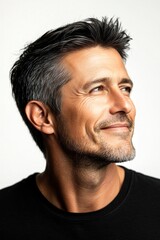 Fototapeta premium Visual idea of style for aging men. Pure white solid background. Modish men's crew cut haircut - midlife white man with black hair. A stylish and confident man with a poised stance.