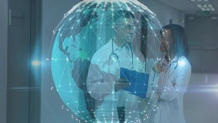 doctors discussing notes in hospital corridor, featuring digital globe network hologram overlay - Powered by Adobe