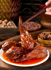 Spicy duck head is a marinated dish using traditional Chinese spices and is a popular street food.
