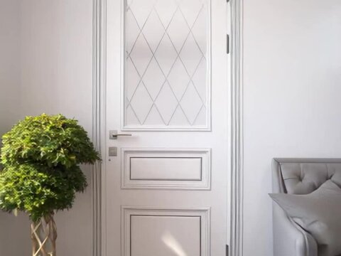Elegant white door with diamond-patterned frosted glass in modern minimalist living room with tufted gray sofa