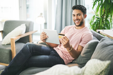 Credit card, portrait and man on sofa on tablet for online shopping, internet purchase or payment...
