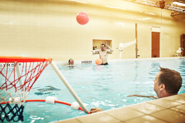 Pool, down syndrome and man with learning disability playing water basketball for a fitness workout. Inclusion, sports and disabled person swimming to exercise, active and be healthy on a fun holiday