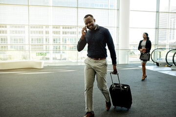 Man, phone call and bag in airport for travel, business contact and trip confirmation. Journalist,...