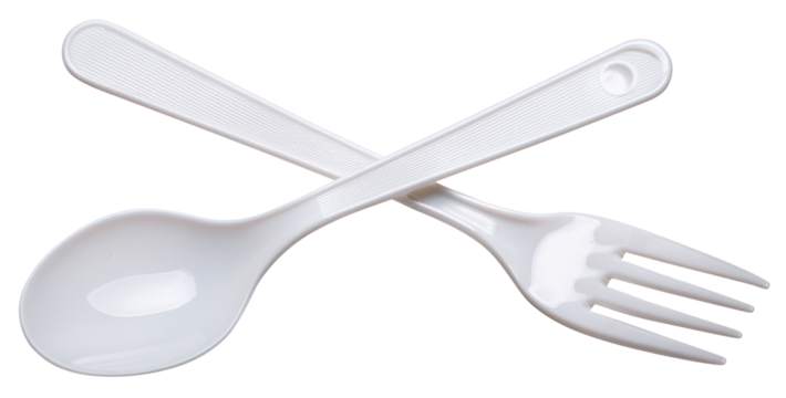 white plastic spoon and fork in cross form isolated on white background