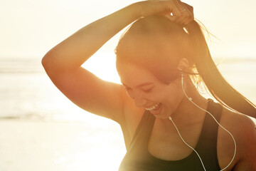 Fitness, beach sunrise and smile with woman prepare for running, workout and summer with music....