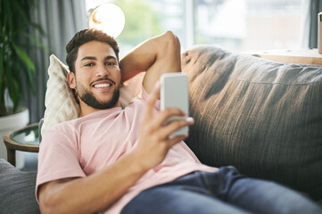 Man, portrait and relax on sofa with phone, social media and comfort with online banking in home....