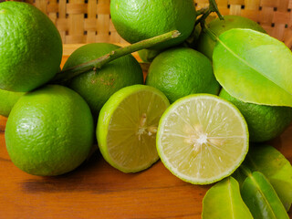 Close up of fresh lime with leaves, whole and half, green limes, natural, fruit