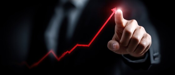 A business professional points to a rising graph, symbolizing growth and success in a dark setting.