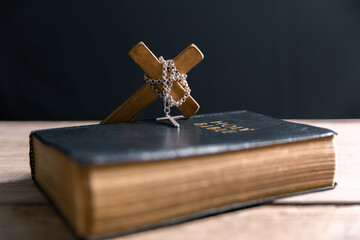 Religious belief concept Close up prayer Christian church service Bible Holy cross Spiritual power Blurred background Desk copy space Heaven God Catholic faith Praise book Jesus worship Gospel symbols