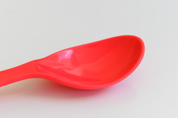 red spoon isolated on white background, plastic cutlery for picnic