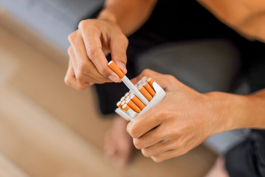 Closeup of man holds a pack of cigarettes in his hands