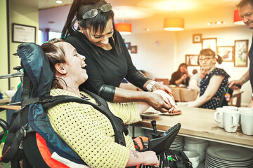 Wheelchair down syndrome disability girl patient in clinic or hospital with nurse or professional...