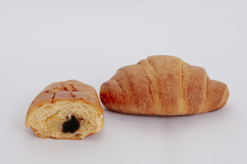 Sliced croissant with bananas and chocolate isolated on white background.