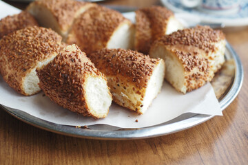 Freshly baked simit on a silver platter in a cozy setting