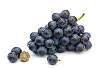 Fototapeta premium A cluster of dark grapes with a stem and some loose grapes on a white background in a studio shot
