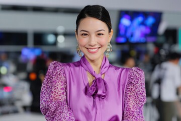 Smiling Asian Woman in Purple Blouse at a TV Studio, News Anchor, Portrait Photography, Blurred Background