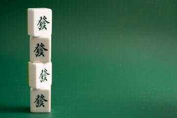 Close-up of mahjong tiles on a green surface,Mahjong (mah jongg, mah-jongg, and mahjongg) is a tile-based game that was developed in the 19th century in China
