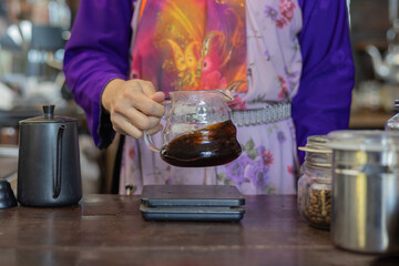 Process drip coffee, Barista start chose coffee bean and Roasting. Barista making drip coffee by pouring spills hot water on coffee ground with prepare filter from copper pot to glass transparent drip