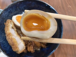 Soft boiled egg on a chopstick