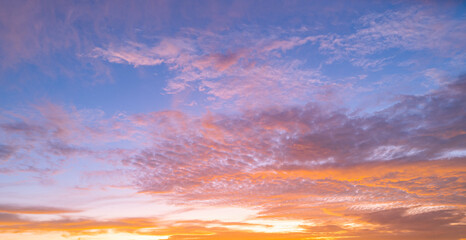 Sky at sunset. Sunrise background. Sunset through clouds on sky. Twilight sky with sunset colors. Peaceful dawn with soft light. Dramatic dusk sunset with clouds. Sunshine in clear sky.