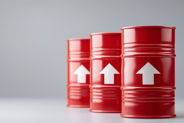 Red arrows pointing upward on oil barrels with a grey background, standing side by side, a stock market concept of rising gas and energy costs, financial insecurity or failure.