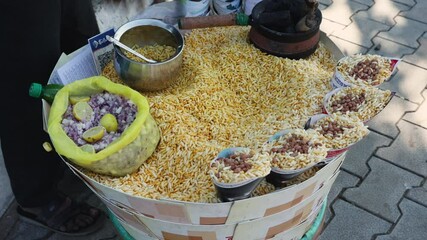 A street food vendor in India prepares dinner for hungry customers in a busy market Capture the essence of street food vendors preparing chaat on bustling Indian streets