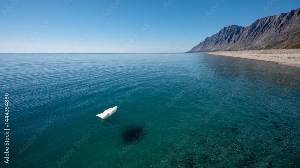 Poster a solitary ice floe floats calmly in the clear blue waters, framed by majestic mountains and a glaci
