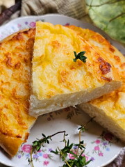 Khachapuri with thyme tea on wooden background