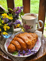 Croissant with coffee and milk on wooden background