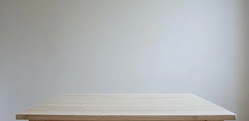 Light wood table against a plain white wall