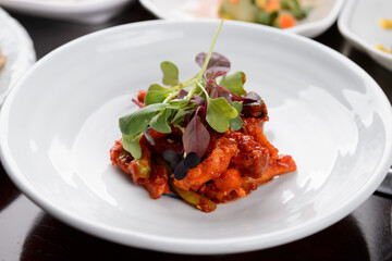 Korean kimchi side dish in a white plate
