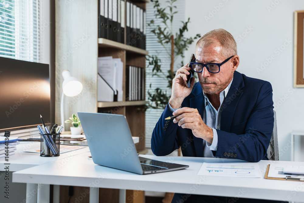 Poster businessman are calculating and working on laptop and document paperwork and phone calling with coll