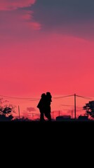 Silhouettes of two people walking against a vibrant sunset sky.