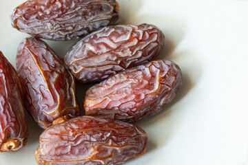 Close view of several freshly dried dates on the plate with copy space