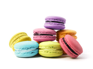 Pile of macaron cookies in various flavours and colours isolated on white background.