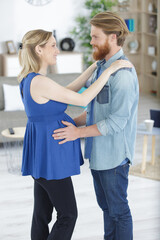 expectant couple dancing in their home